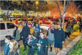  ?? JOSHUA SUDOCK/THE ORANGE COUNTY REGISTER VIA AP ?? Protesters block traffic Wednesday during a protest after a video surfaced appearing to show a policeman firing a single round during an off-duty tussle with a 13-year-old boy.