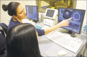  ?? Ned Gerard / Hearst Connecticu­t Media ?? Tania Grgurich, Clinical Associate Professor of Diagnostic Imagining, looks at the result of CT Scan of a human skull at Quinnipiac University’s School of Health Science in North Haven on Jan. 3. Quinnipiac is taking diagnostic imaging of the skeletal remains of three humans found recently buried during the renovation of an 18th century house in Ridgefield.