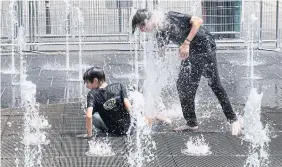  ?? RYAN REMIORZ THE CANADIAN PRESS FILE PHOTO ?? People try to beat the 30 C heat in Montreal earlier this month. A new rapid extreme weather event attributio­n pilot program will let Enviroment Canada quickly determine the cause of heat waves.