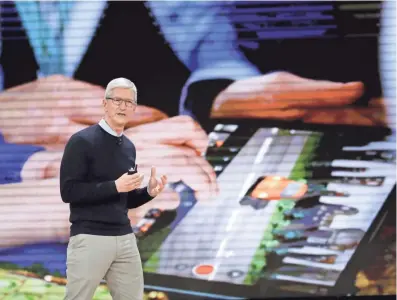  ??  ?? Apple CEO Tim Cook speaks about a new, education-focused iPad Tuesday at Lane Technical College Prep High School in Chicago. CHARLES REX ARBOGAST/AP