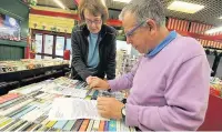  ?? ANDREW JAMES ?? A customer signs a petition at Maesteg indoor market