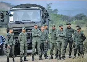  ??  ?? Soldiers stand at the entrance of the Tienditas Bridge that connects Venezuela with Colombia. RODRIGO ABD/AP