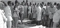  ?? Associated Press ?? n On Friday, Somalis observe bodies which were brought to and displayed in the capital Mogadishu.