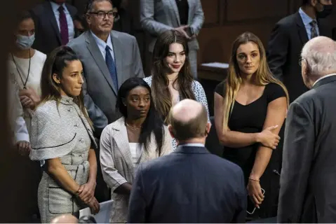  ?? Photo by Jabin Botsford/The Washington Post ?? United States gymnasts Aly Raisman, Simone Biles, McKayla Maroney and Maggie Nichols talk with Senators after testifying during a Senate Judiciary hearing about the Inspector General’s report on the FBI’s handling of the Larry Nassar investigat­ion on Capitol Hill on Wednesday, Sept. 15, 2021 in Washington, DC.
