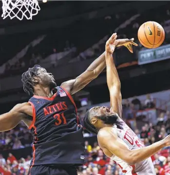  ?? ERIK VERDUZCO LAS VEGAS REVIEW-JOURNAL VIA AP ?? Aztecs big man Nathan Mensah blocks a shot by UNLV guard EJ Harkless (55) during the second half.