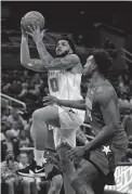  ?? AP ?? The Hornets' Miles Bridges goes up for a shot past the Magic's Wendell Carter Jr. on Wednesday night in Orlando, Fla. Bridges finished with 31 points.