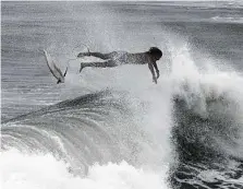  ?? Dan Anderson / Associated Press ?? A surfer crashes into waves off Pensacola Beach as rough surf and rip currents from Alberto strike the north Florida coast.