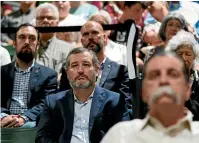 ?? AP ?? Senator Ted Cruz, R-Texas, centre, attends a prayer vigil in Uvalde. The vigil was held to honour the victims killed in this week’s shooting at Robb Elementary School.