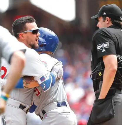  ?? AP ?? Kyle Schwarber is restrained by Javy Baez after being ejected by umpire John Tumpane for arguing a called third strike Sunday.