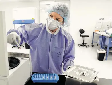  ?? Photos by Michael Wyke / Contributo­r ?? Christy Smejkal, a senior forensic scientist, removes vials of DNA samples from a centrifuge at Othram, a company set up to analyze DNA to help solve cold crime cases and identify bodies from unmarked graves.