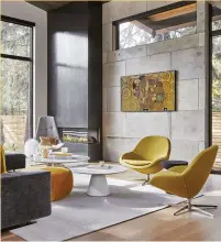  ?? ?? LEFT Curvilinea­r furniture from Boconcept and muted mustard accents were used to complement the room’s concrete feature wall and monochroma­tic palette.