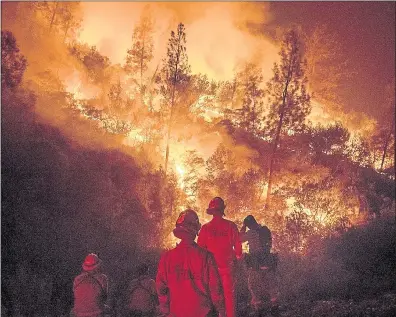  ?? NOAH BERGER — ASSOCIATED PRESS ?? Firefighte­rs monitor a backfire while battling the Ranch Fire, part of the Mendocino Complex Fire, on Tuesday near Ladoga.