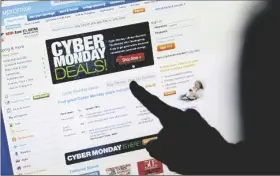  ?? PAUL SAKUMA/AP ?? In this Nov. 29, 2010, file photo, a consumer looks at Cyber Monday sales on her computer at her home in Palo Alto, Calif. Consumers are expected to spend between $10.2 billion and $11.3 billion on Monday, making it once again the biggest online shopping day of the year, according to Adobe Digital Economy Index.