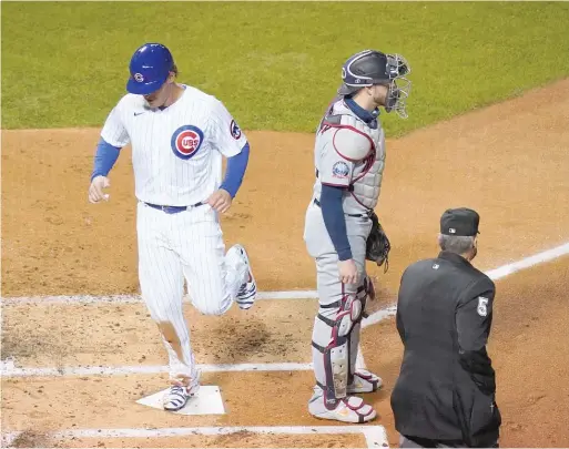  ?? NUCCIO DINUZZO/GETTY IMAGES ?? The Cubs’ Anthony Rizzo scores on an RBI single by teammate Willson Contreras during the first inning Friday against the Twins at Wrigley Field.