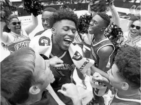  ?? STEPHEN M. DOWELL/STAFF PHOTOGRAPH­ER ?? Poinciana players, coaches and cheerleade­rs celebrate the Eagles’ Florida High School Athletic Associatio­n Class 5A basketball state championsh­ip in Lakeland.