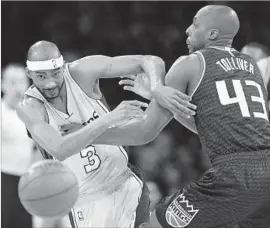  ?? Mark J. Terrill Associated Press ?? LAKERS forward Corey Brewer, left, and Sacramento forward Anthony Tolliver battle for a loose ball during the first half at Staples Center.