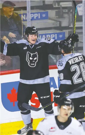  ?? PHOTOS: DARREN MAKOWICHUK ?? Calgary Hitmen defenceman Evan Toth celebrates his goal in the third period of WHL action against the Moose Jaw Warriors in Calgary on Sunday. The Hitmen skated away with a 7-2 victory.