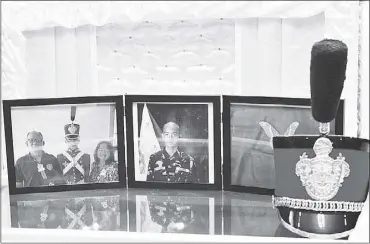  ?? – Gerry Lee Gorit ?? Photos of PMA cadet Darwin Dormitorio and his cap are displayed on top of his coffin at the Cosmopolit­an Funeral Home in Cagayan de Oro.