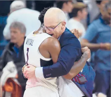  ?? BRAD HORRIGAN/HARTFORD COURANT ?? Christian Vital and Dan Hurley share a moment after UConn sealed its 62-59 victory over Florida at Gampel Pavilion on Nov. 17.