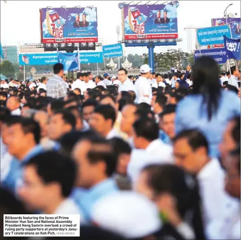  ?? HONG MENEA ?? Billboards featuring the faces of Prime Minister Hun Sen and National Assembly President Heng Samrin overlook a crowd of ruling party supporters at yesterday’s January 7 celebratio­ns on Koh Pich.