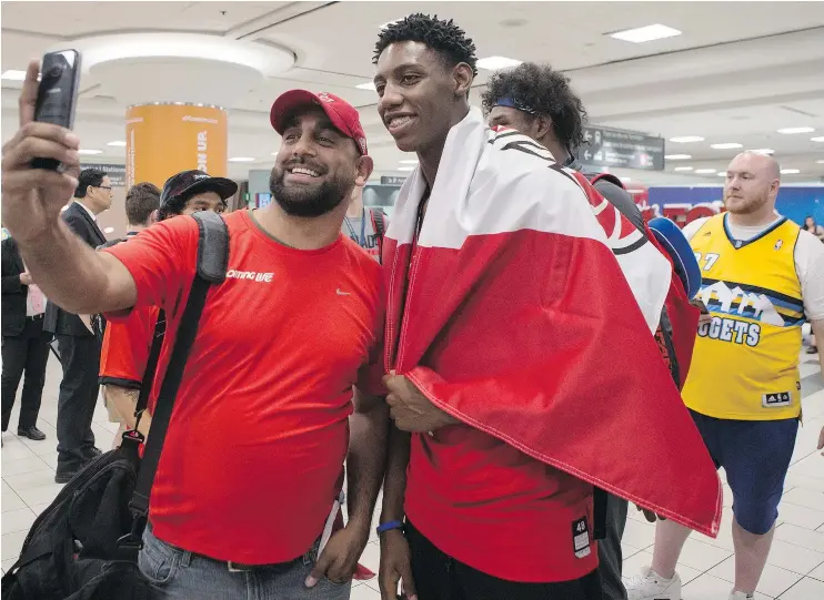  ?? — THE CANADIAN PRESS ?? RJ Barrett, right, was greeted by well-wishers at Toronto’s Pearson airport Monday after returning from winning gold at the under-19 FIBA World Cup in Cairo.