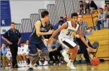  ?? DIGITAL FIRST MEDIA FILE ?? Episcopal’s Matt Dade, right, dribbling in a game against Malvern Prep last season, scored 22 points Friday to lead the Churchmen to a 69-66 victory over Abraham Lincoln.