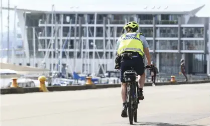  ?? Photograph: Hagen Hopkins/Getty Images ?? A police officer on patrol during the first day of a nationwide lockdown in Wellington, New Zealand.