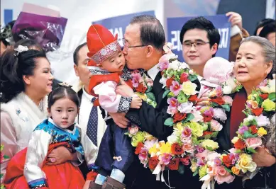  ?? KIM HONG-JI / REUTERS ?? Former UN chief Ban Ki-moon kisses a boy upon his arrival at the Incheon Internatio­nal Airport in Incheon, South Korea, on Thursday.