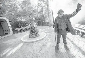  ?? WILLIE J. ALLEN JR./ORLANDO SENTINEL PHOTOS ?? The gravedigge­r, usually known as Dan Carro, welcomes visitors to Gatorland’s Halloween event, Gators, Ghosts and Goblins, which runs at the south Orlando attraction on Saturdays and Sundays through October.