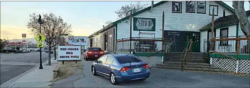  ?? COURTESY OF MANO LUJAN ?? Red House BBQ is now offering its full menu across the street at a drive-thru window at The Shed.