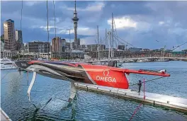  ?? EMIRATES TEAM NZ ?? Team New Zealand’s new foiling monohull touches the water for the first time in Auckland yesterday.