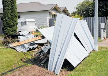  ?? Photo / Duncan Brown ?? A trail of debris was left behind when the car crashed through three properties.