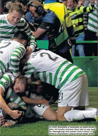  ??  ?? Victor Wanyama is swamped by team-mates after his header ensured there was no way back for Helsingbor­gs and sealed Celtic’s place in today’s Champions League group stage draw
