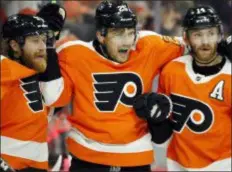  ?? THE ASSOCIATED PRESS ?? The Flyers’ James van Riemsdyk, standing between, Jake Voracek, left, and Sean Couturier, admits he can’t help but miss Toronto at least a little bit. JVR returns to take on the Maple Leafs Saturday night.