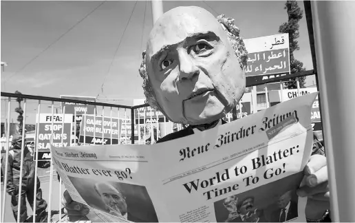  ?? FABRICE COFFRINI / GETTY IMAGES ?? A demonstrat­or dressed as former FIFA president Sepp Blatter takes part in a protest in Zurich on May 28.