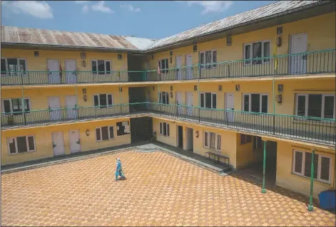  ??  ?? A woman walks inside an empty school closed the past four months because of the coronaviru­s pandemic in Srinagar.