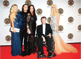  ?? — AP photos ?? Third from left, Mary Travis and artist Randy Travis, seated, with family on the red carpet of the Country Music Hall of Fame Medallion Ceremony at the Country Music Hall of Fame and Museum on Sunday, in Nashville, Tenn.