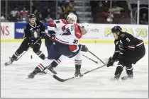  ?? Herald photo by Tijana Martin ?? Logan Barlage, one of the Lethbridge Hurricanes latest trade acquisitio­ns , battles Mason McCarty of the Red Deer Rebels during a game at the Enmax Centre on Tuesday night.