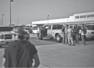  ??  ?? Day laborers seek work in a Home Depot parking lot in southweste­rn Houston on Saturday as the region starts to recovery from Hurricane Harvey.