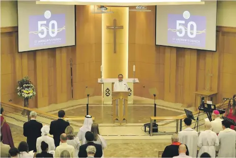  ??  ?? Above, chaplain Andy Thompson speaks at St Andrew’s 50th anniversar­y celebratio­n yesterday. Left, from right, Sheikh Nahyan bin Mubarak, Minister of Tolerance, Michael Lewis, Anglican Bishop in Cyprus and the Gulf and Rev Thompson