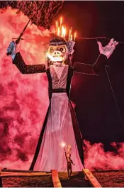  ?? JIM WEBER/NEW MEXICAN FILE PHOTO ?? Zozobra Fire Dancer Helene Luna steps away as Old Man Gloom starts to burn during the 99th burning of Zozobra in September at Fort Marcy Park. The 100th burning may be months away, but nearly 60% of tickets have been sold, and several initiative­s to celebrate this year’s centennial have been approved.