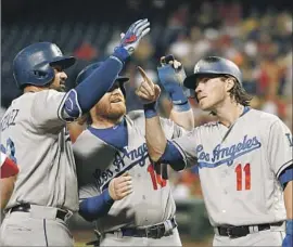  ?? Tom Mihalek Associated Press ?? ADRIAN GONZALEZ, left, celebrates his three-run home run in the fourth inning with Dodgers teammates Justin Turner and Josh Reddick (11).