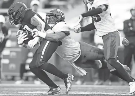  ??  ?? Memphis Express linebacker Demarquis Gates tackles Birmingham Iron wide receiver Tobias Palmer on Sunday. JOE RONDONE/THE COMMERCIAL APPEAL