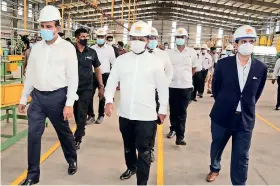  ??  ?? State Minister of Aviation and Developmen­t of Export Zones, D. V. Chanaka, and Board of Investment (BOI) Chairman Sanjaya Mohottala during an inspection tour of the plant last week. Also in the picture is Onyx Group Chairman Nandana Lokuwithan­a