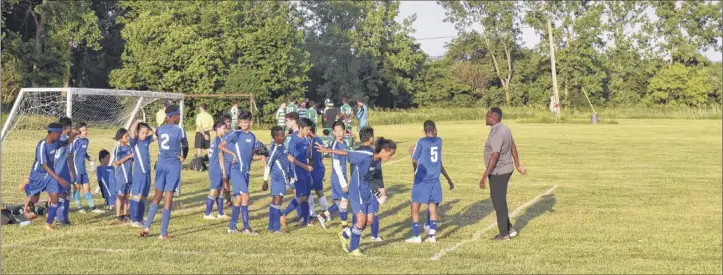  ?? Massarah mikati / times union ?? the risse Soccer team prepares to play against east Greenbush at Albany’s Hoffman Park on June 13. Below, risse Soccer team Coach Ali Abdalla, right, attended his players’ graduation from Hackett middle School. Sa Kler moo, third from the right, graduated at the top of his class. the Karen teen spent his early years in a refugee camp in thailand.