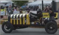  ?? PHOTOS BY PETE BANNAN - DIGITAL FIRST MEDIA ?? A classic race car takes the turn onto Lincoln Highway in the for the third annual Coatesvill­e Grand Prix. The 2.2mile course took the racers down the Lincoln Highway and around the street of the city on a timed circuit.