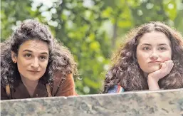  ??  ?? “Landline” follows two sisters (Jenny Slate, left, and Abby Quinn) who discover their father, played by John Turturro, is having an affair.