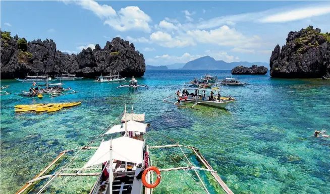  ?? ISTOCK ?? Excursion boats dot the small lagoon in El Nido, Palawan.