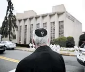  ?? MATT ROURKE/AP ?? Rabbi Jeffrey Myers of the Tree of Life Congregati­on stands across from the synagogue where 11 people were shot and killed Oct. 27 as Saturday services began.