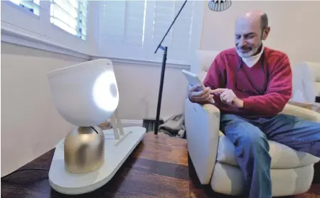  ?? TNS PHOTO ?? SPEAK UP: Barry Sardis interacts with an ElliQ prototype personal robot he is testing in his San Jose, Calif., home.